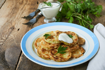 Fried zucchini with sour cream and fresh herbs
