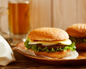 Fresh delicious burger, served on wooden board