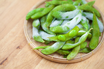 studio shot of Japanese style boiled beans EDAMAME on basket..