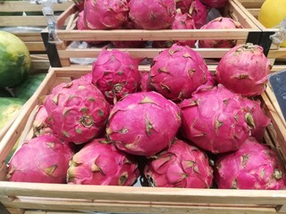 Freshly harvested organic dragon fruit on display for sale at local farmer's market departmental store.
