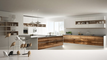 White table top or shelf with minimalistic bird ornament, birdie knick - knack over blurred contemporary wooden kitchen, modern interior design