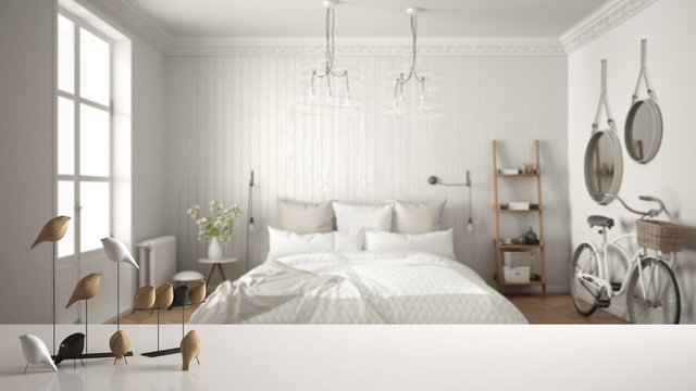 White table top or shelf with minimalistic bird ornament, birdie knick - knack over blurred scandinavian bedroom, modern interior design