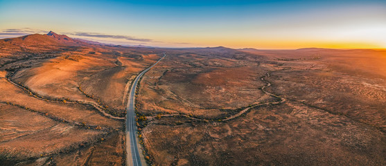 The Outback Highway passing through Flinders Ranges at dusk - aerial panorama - 216092718