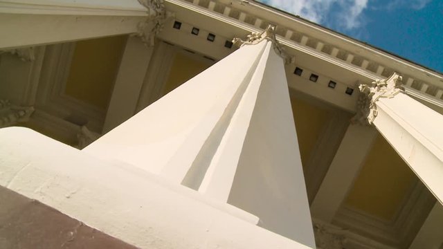 Close-up of a line of Greek-style columns. Scene. Old building with columns