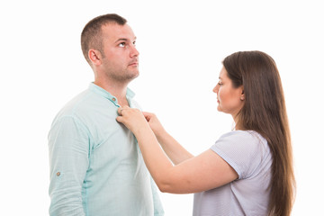 Portrait of young happy couple buttoning shirt gesture