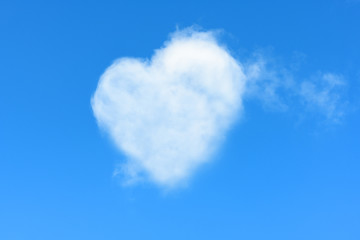 Naklejka na ściany i meble It is beautiful natural cloud in a form of a heart in a blue sky. It is the concept of unearthly love and passion, sublime feelings.