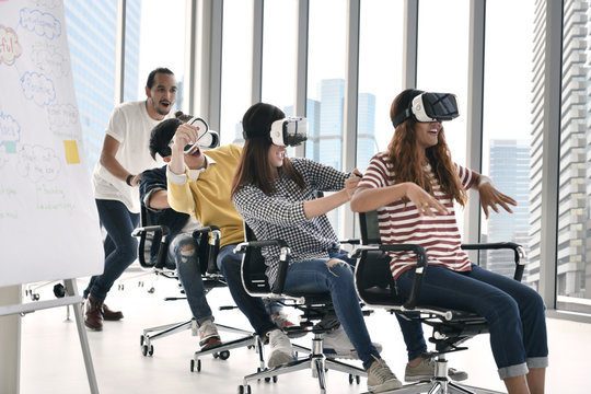 Group Of Young Businesspersons Having Fun With Vr Virtual Reality At Office