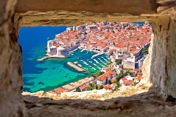 Dubrovnik historic city and harbor aerial view through stone window from Srd hill,