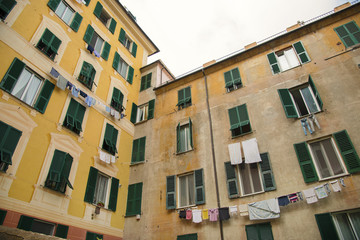 Fototapeta na wymiar Building with hanging laundry bellow the windows in the center of Genoa city