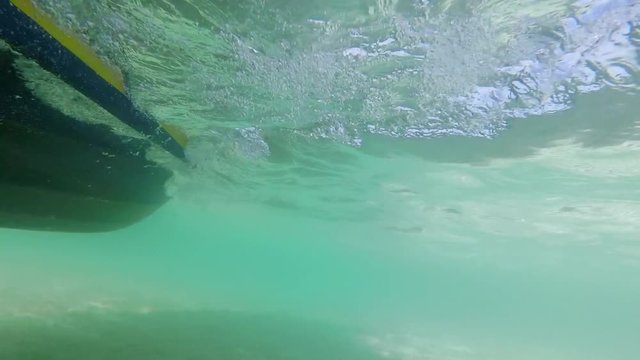 A clip of moving speedboat viewed from the side and underwater