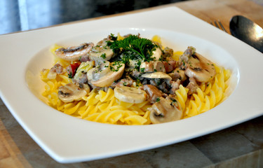  Fusilli pasta served with mushroom sauce .