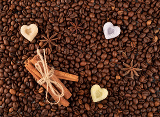 Roasted coffee beans witn sinnamon,anise and sugar in the shape of heart, can be used as a background, selective focus