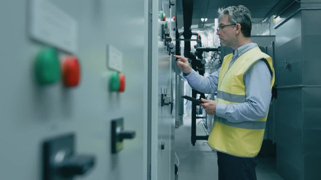 Engineer / Factory Worker Programming / Setting Up Machinery on a Power Station