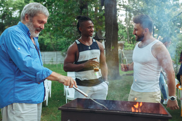 Group of friends making barbecue in the backyard. concept about good and positive mood with friends