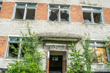 Broken Windows and glass in an old, abandoned brick house