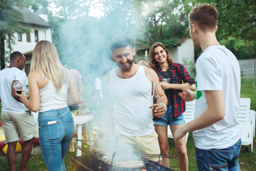 Group of friends making barbecue in the backyard. concept about good and positive mood with friends