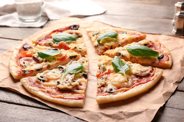 Tasty sliced pizza on wooden table