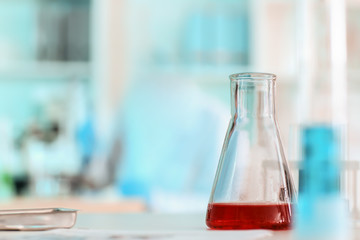 Test flask with sample on table in laboratory