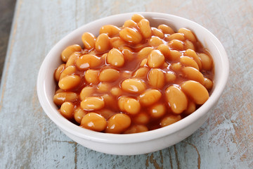 baked beans in tomato sauce in white  dish
