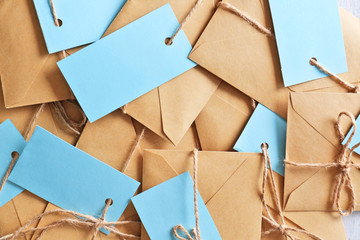 Brown envelopes with tags as background, top view. Mail service