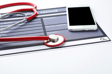 Stethoscope with phone and medical record on white background. Health care concept