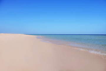 Fototapeta na wymiar Beautiful view of sandy beach on sunny summer day