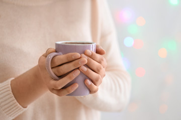 Woman with mug of hot chocolate, closeup