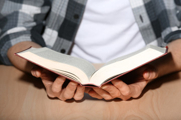Young man reading book, closeup
