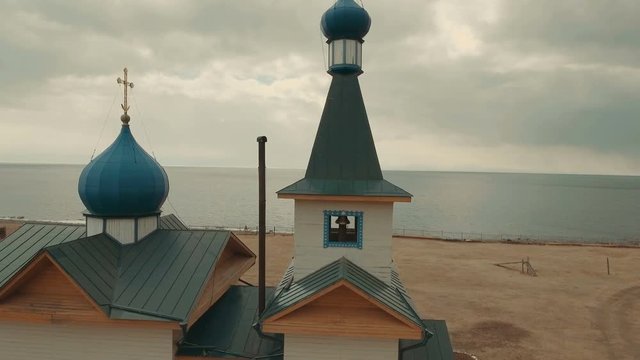 Wooden church on the lake aerial view
