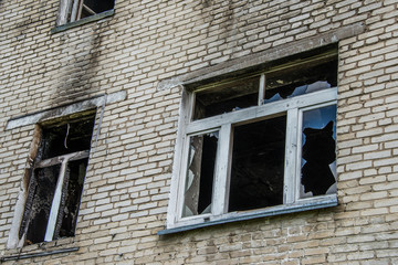 Broken Windows and glass in an old, abandoned brick house