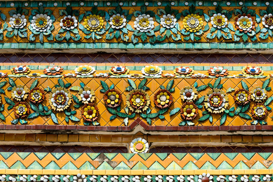 Close up beauitful mosaic tiles of large stupas in Wat Pho or Wat Phra Chetuphon Vimolmangklararm Rajwaramahaviharn is one of Bangkok's oldest temples, THAILAND
