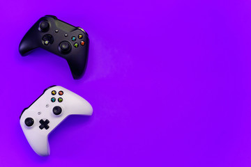 Black and white joystick xbox one s gamepad, game console on violet colourful trendy modern fashion pin-up background. Computer gaming competition videogame control confrontation concept © Юлия Завалишина