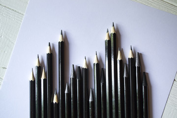 The set of grey pencils on a white background. Tools for drawing on the desk.