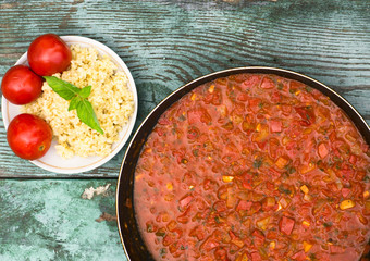 large pan of Italian sauce with tomatoes