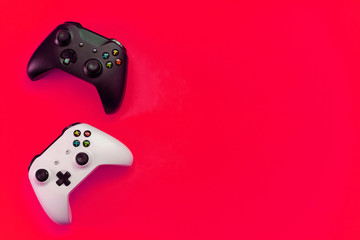Black and white joystick xbox one s gamepad, game console on red colourful trendy modern fashion pin-up background. Computer gaming competition videogame control confrontation concept © Юлия Завалишина