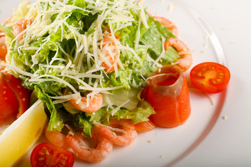 Caesar salad with shrimps and salmon