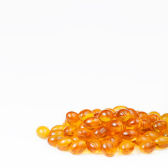 Orange fish oil capsules on white background. Text space. Sport and health concept. Omega 3.