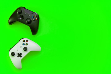 Black and white joystick xbox one s gamepad, game console on green colourful trendy modern fashion...