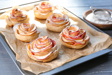 Obraz na płótnie Canvas Tasty rose shaped apple pastry on baking tray