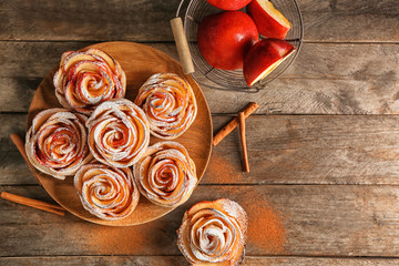 Tasty rose shaped apple pastry on wooden table