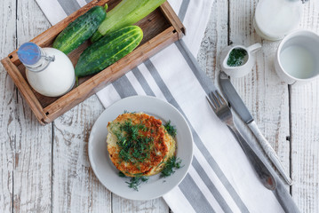 Delicious pancakes from courgettes and fresh vegetables with sour cream and dill
