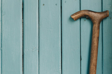 Old age and a wooden vintage cane. Background. Free place.