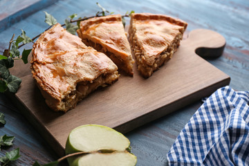 Pieces of apple pie on wooden board