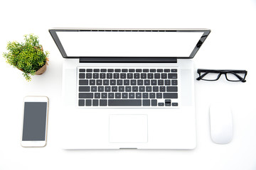 Top view with working desk with laptop,cellphone,notebook pencil coffee cup and eyeglasses in the...