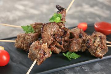 Barbecue skewers with juicy meat on plate