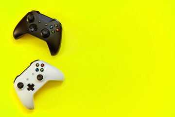 Black and white joystick xbox one s gamepad, game console on yellow colourful trendy modern fashion pin-up background. Computer gaming competition videogame control confrontation concept