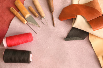 Set of tools with threads on leather in workshop