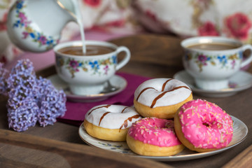 Breakfast in bed with coffee and donuts