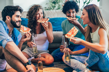 Group of young friends eating pizza.Home party.