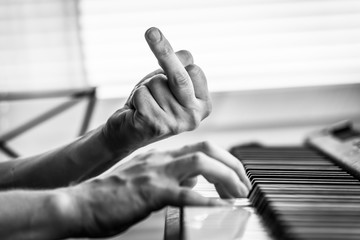 play the piano and show the middle finger.